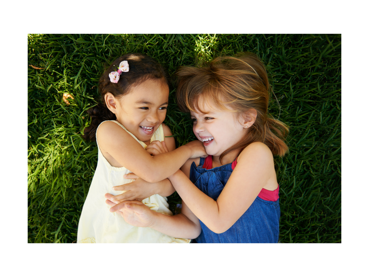 Two young girls laughing together