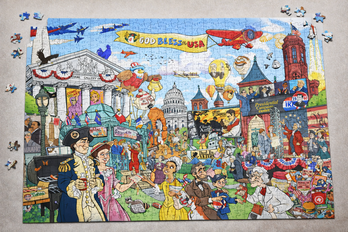 Almost-finished USA History Trivia Puzzle on a table: a 1,000-piece illustrated scene of American history with the Capitol dome, a God Bless the USA banner and famous figures from the nation's past