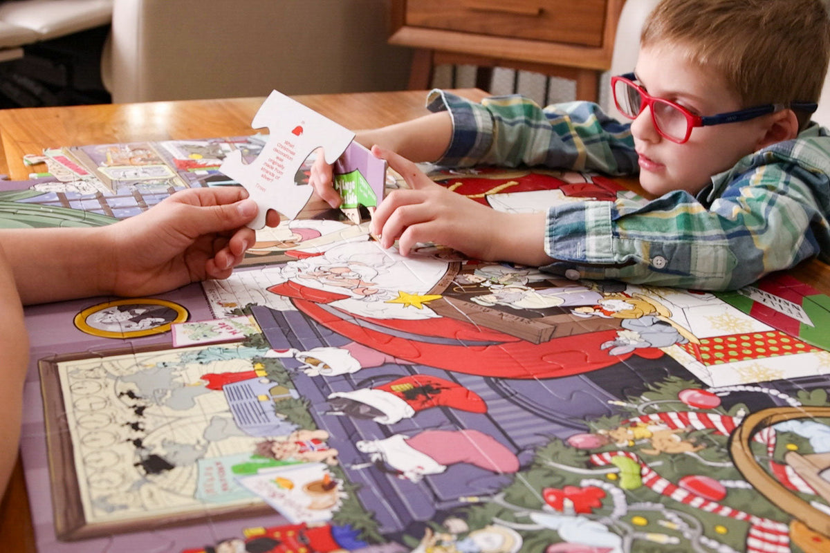 Kids building the Christmas Trivia 72-piece jumbo floor puzzle together, with a trivia question on the back of every piece
