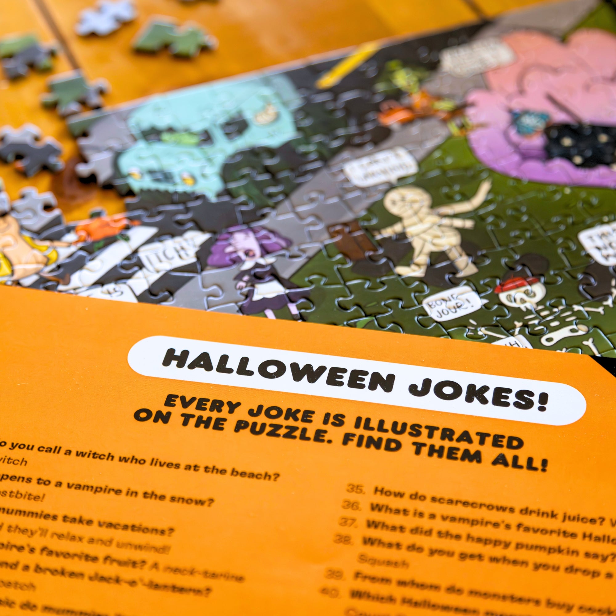 Halloween-themed puzzle with jokes lying on the corresponding Halloween Joke Puzzle