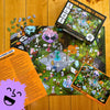 Halloween-themed puzzle with pieces scattered on a wooden surface, showing Halloween Jokes insert and puzzle reference photo insert