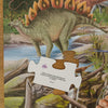 Dinosaur puzzle with a Stegosaurus in a natural setting plus a puzzle piece with dinosaur trivia on the back of it.