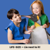 Two children holding a large life-size penguin puzzle against a blue background.